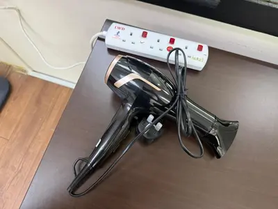 a vacuum cleaner and a remote control on a table at Bondfire Ipoh Bercham Karaoke & Homestay 5pax in Ipoh