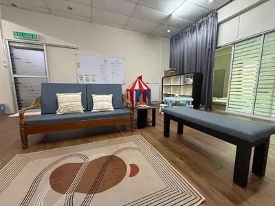 a room with two beds and a couch and a rug at Bondfire Ipoh Bercham Karaoke & Homestay 5pax in Ipoh