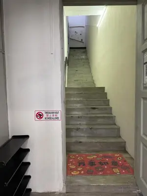 a stairway with a sign on the side of a door at Bondfire Ipoh Bercham Karaoke & Homestay 5pax in Ipoh