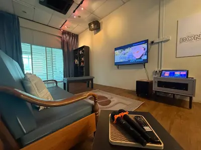 a living room with a couch and a tv at Bondfire Ipoh Bercham Karaoke & Homestay 5pax in Ipoh
