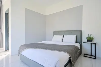 a bed with white sheets and pillows in a room at Family Home In Brinchang Emerald Avenue Apartment Clover Home 3-22 in Brinchang