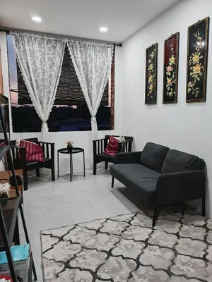 a living room with a couch and some chairs at Rumah Adaminha, Roomstay with pool Simpang, Taiping in Taiping