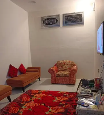 a living room with a couch and a chair at Homestay Ismail LEKIR in Sitiawan