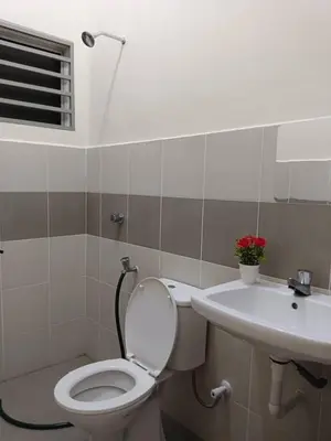 a bathroom with a toilet and a sink at Homestay Ismail LEKIR in Sitiawan