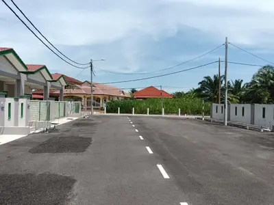 an empty street with houses in the background at Homestay Ismail LEKIR in Sitiawan