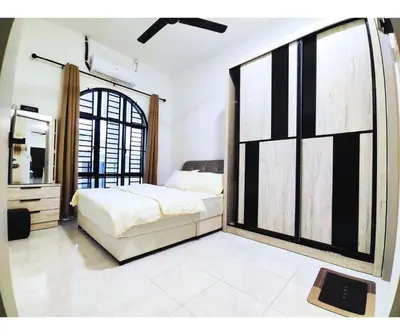 a bedroom with a bed and a large window at The Silverlakes Homestay in Batu Gajah