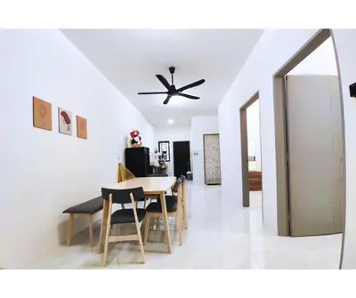a dining room with a ceiling fan and a table at The Silverlakes Homestay in Batu Gajah