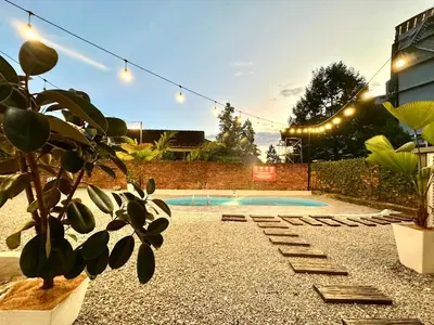 a backyard with a swimming pool with lights and a plant at Lakeside Pool Villa in LakeGarden & Zoo in Taiping