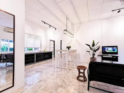 a living room with a couch and a table at Lakeside Pool Villa in LakeGarden & Zoo in Taiping