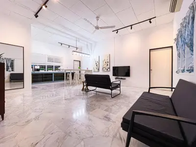 a large living room with a couch and a tv at Lakeside Pool Villa in LakeGarden & Zoo in Taiping