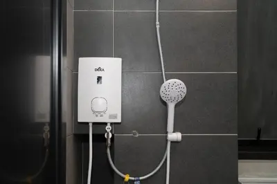 a shower with a hair dryer on a wall at Creamy French at Urban Suite in George Town