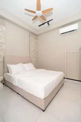 a white bedroom with a bed and a ceiling fan at Creamy French at Urban Suite in George Town