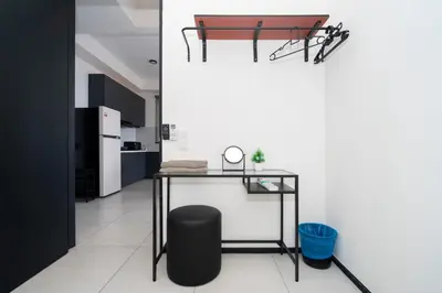 a kitchen with a table and a black chair at Creamy French at Urban Suite in George Town