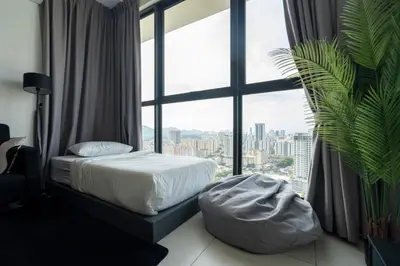 a bedroom with a bed and a large window at Creamy French at Urban Suite in George Town