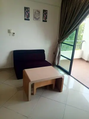 a living room with a couch and a coffee table at Marina sunset view in Lumut