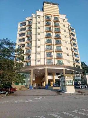 a large white building with a parking lot in front of it at Marina sunset view in Lumut