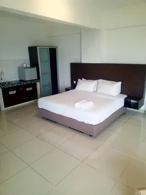 a bedroom with a large white bed in a room at Marina sunset view in Lumut