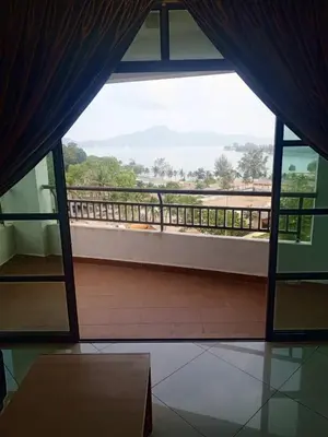 a view of a balcony from a room with a window at Marina sunset view in Lumut