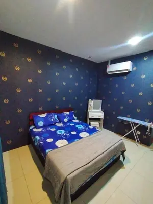 a bedroom with a bed and a blue wall at Bern's Homestay Manhattan Condo, Ipoh-GROUND FLOOR, POOLSIDE, FREE PARKING and WiFi in Ipoh