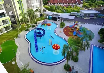 an overhead view of a swimming pool at a resort at Bern's Homestay Manhattan Condo, Ipoh-GROUND FLOOR, POOLSIDE, FREE PARKING and WiFi in Ipoh