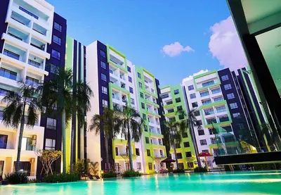 a swimming pool in front of some tall buildings at Bern's Homestay Manhattan Condo, Ipoh-GROUND FLOOR, POOLSIDE, FREE PARKING and WiFi in Ipoh