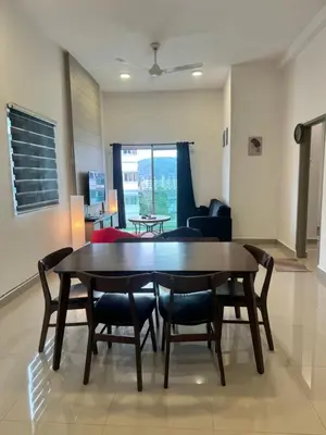 a dining room table and chairs in a living room at AYAAN FIFA HOME at Quintet Private Parking in Tanah Rata