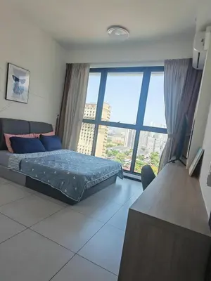 a bedroom with a bed and a large window at Urban Suite in George Town