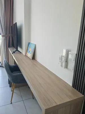a wooden desk in a room with a blue chair at Urban Suite in George Town