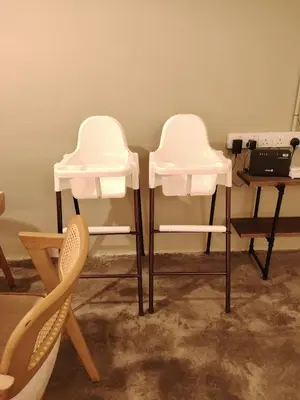 two white chairs sitting next to a table with a laptop at Mokū Georgetown Pre-war House 4BR 5-14pax in George Town