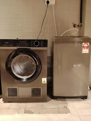 a washer and dryer in a room at Mokū Georgetown Pre-war House 4BR 5-14pax in George Town
