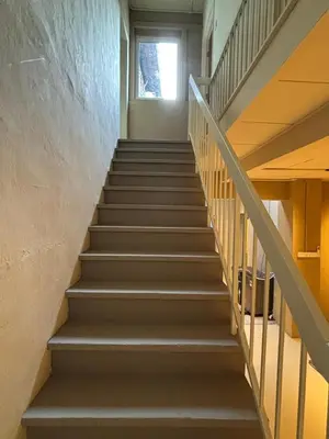 a staircase in a building with a window at Mokū Georgetown Pre-war House 4BR 5-14pax in George Town