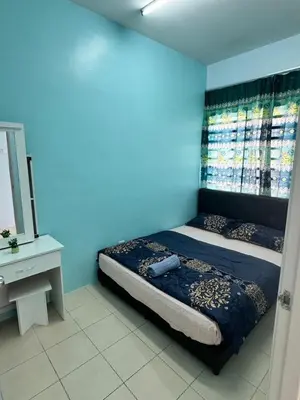 a bedroom with a bed with a blue wall at AYAAN Fifa Game HOMESTAY At Tanah Rata with Wifi in Tanah Rata