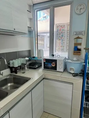a kitchen with a sink and a window in it at AYAAN Fifa Game HOMESTAY At Tanah Rata with Wifi in Tanah Rata