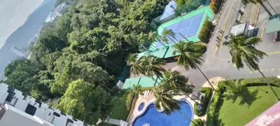 an aerial view of a resort with palm trees and the ocean at sri sayang apartment in Batu Ferringhi