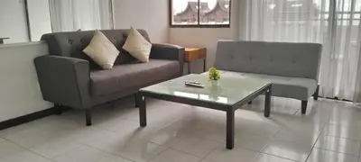 a living room with a couch and a coffee table at sri sayang apartment in Batu Ferringhi
