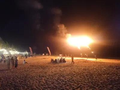 a group of people on a beach at night at sri sayang apartment in Batu Ferringhi