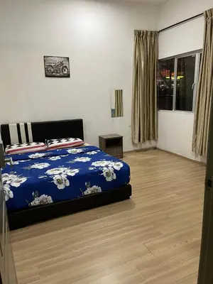 a bedroom with a bed with a blue comforter at Imagine world quintet apartment in Tanah Rata