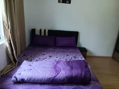 a purple bed in a bedroom with a purple comforter at Imagine world quintet apartment in Tanah Rata