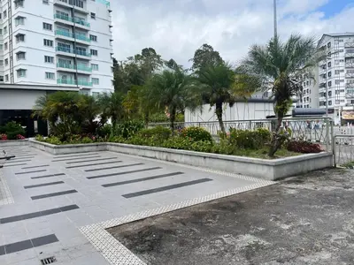 a parking lot in a city with palm trees and buildings at Imagine world quintet apartment in Tanah Rata