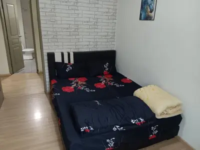 a bed with black sheets and red flowers on it at Imagine world quintet apartment in Tanah Rata