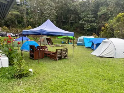 a group of tents and tables and chairs in the grass at BANGALOW Cameron Highlands in Tanah Rata