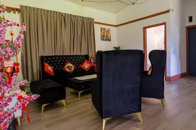 a living room with two chairs and a couch at BANGALOW Cameron Highlands in Tanah Rata