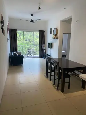a living room with a dining room table and chairs at Golden Hills 2 Bedroom Apartment in Brinchang