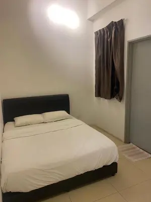 a bedroom with a white bed with a black headboard at Golden Hills 2 Bedroom Apartment in Brinchang