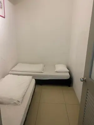 a small room with two beds in it at Golden Hills 2 Bedroom Apartment in Brinchang