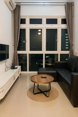 a living room with a black couch and a coffee table at Riverine Sapphire, 10-3A in Gua Sai