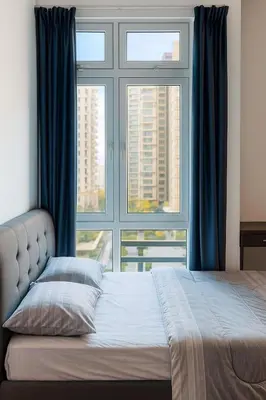 a bedroom with a bed and a large window at Riverine Sapphire, 10-3A in Gua Sai
