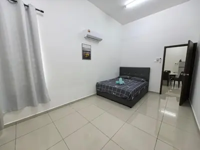 a bedroom with a bed in a room with a mirror at Padang Serai Taman Ria 61 in Padang Serai