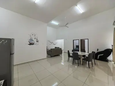 a living room with a table and chairs in it at Padang Serai Taman Ria 61 in Padang Serai