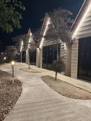 a walkway in front of a building at night at MI LE GARDEN Chalet in Sekincan